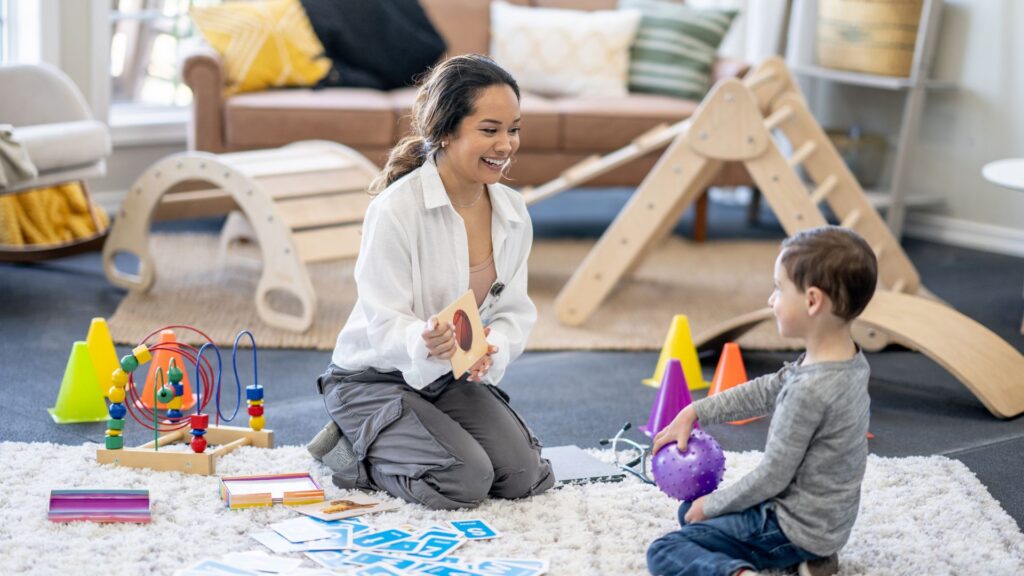 Therapist and child practicing skills through play during ABA therapy, guided by the 7 dimensions of ABA
