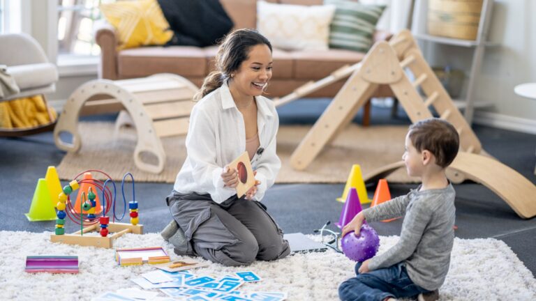 Therapist and child practicing skills through play during ABA therapy, guided by the 7 dimensions of ABA