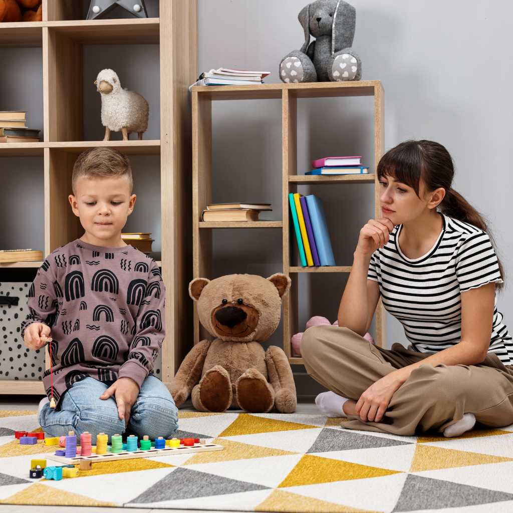 Child with autism playing with colorful toys while therapist observes in supportive learning environment