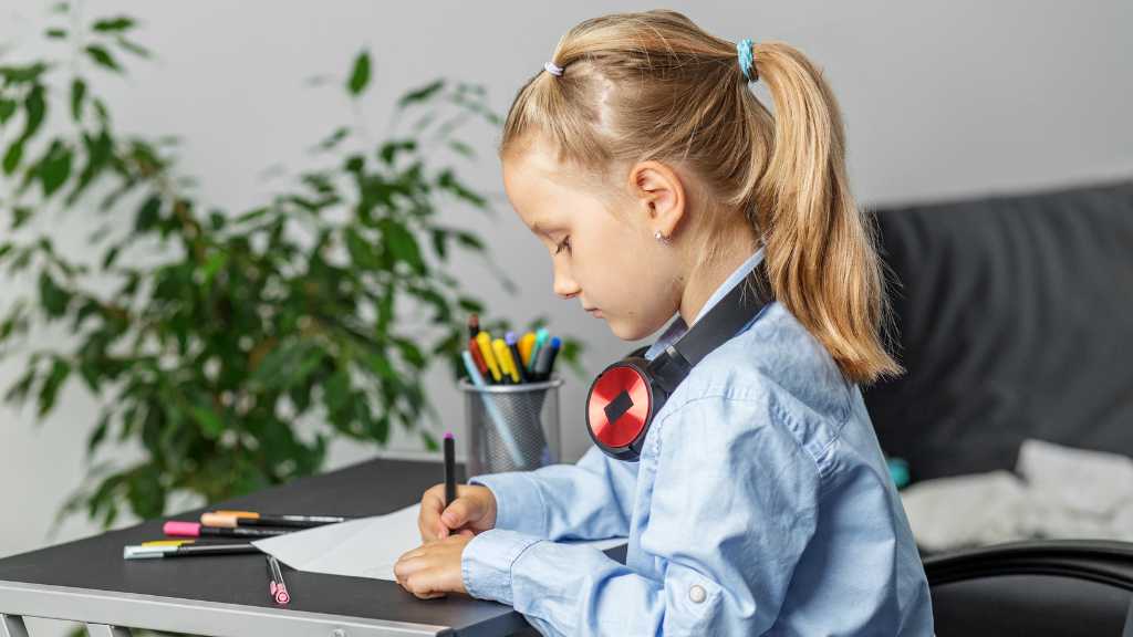 Child deeply focused on a precise task, illustrating splinter skills in autism and isolated areas of strong ability.