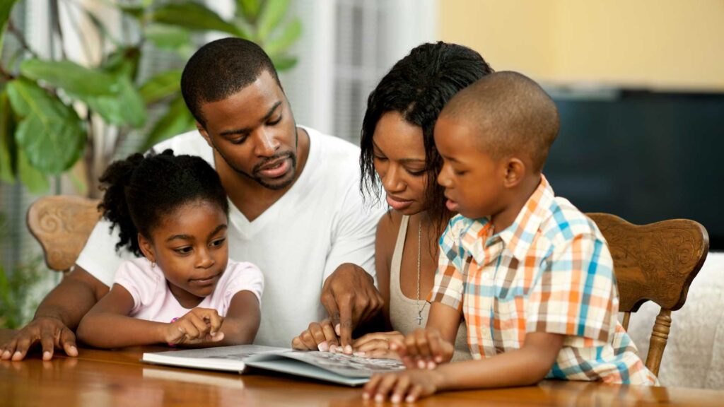Family reading together at home, representing the importance of books for kids with autism, books for teens with autism, and books about autism.