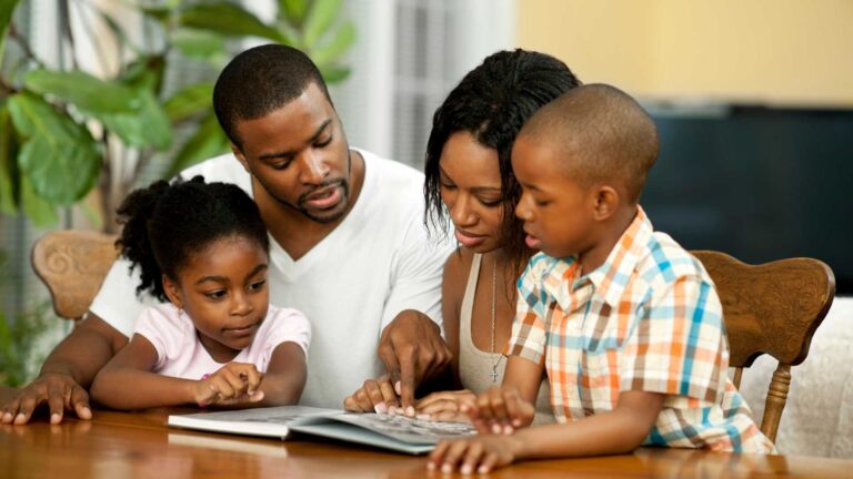 Family reading together at home, representing the importance of books for kids with autism, books for teens with autism, and books about autism.