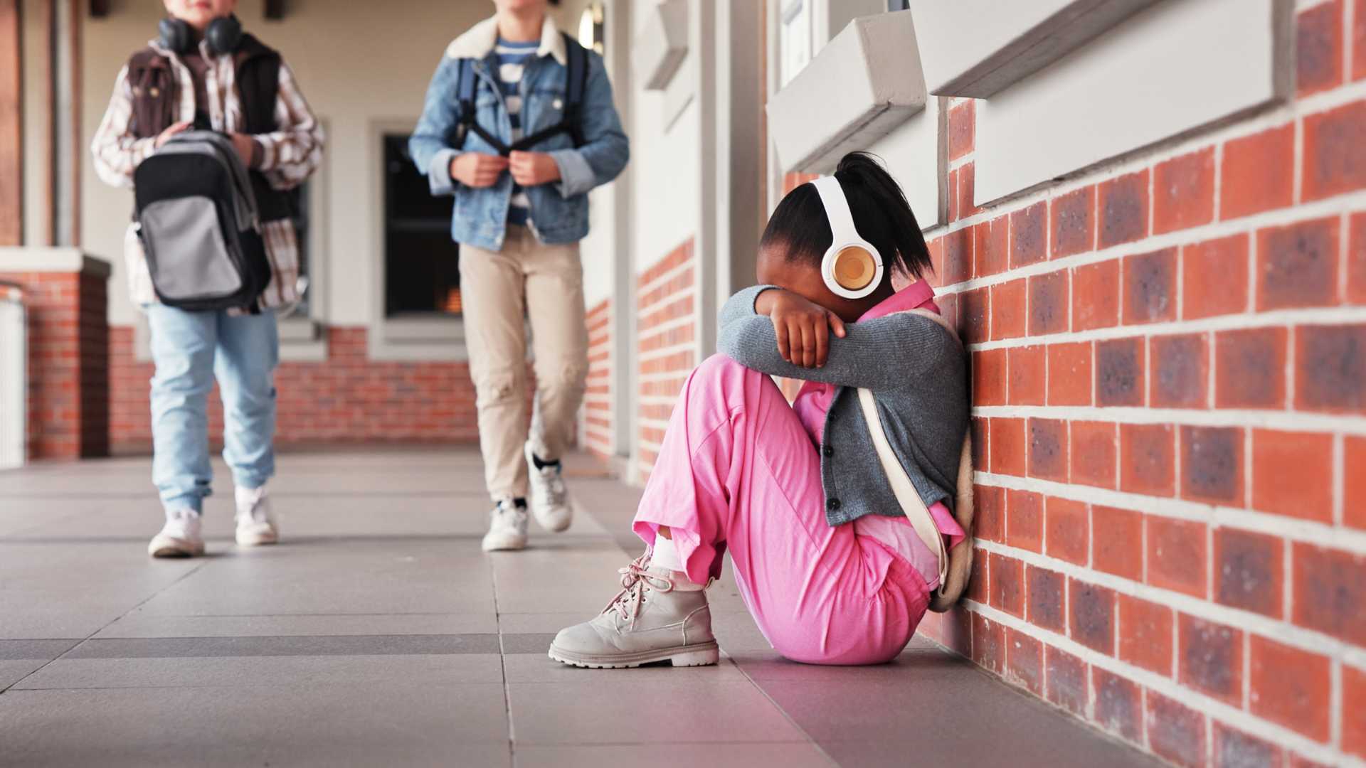 Child sitting with headphones, showing the impact of sensory issues in autism on the brain