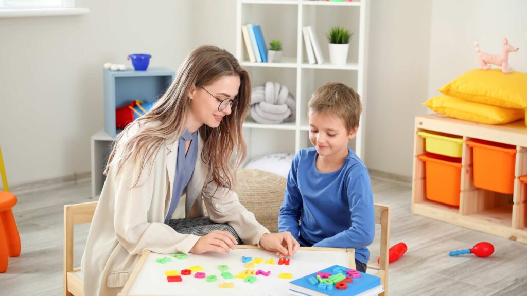 BCBA using play-based activities to teach a child during ABA therapy