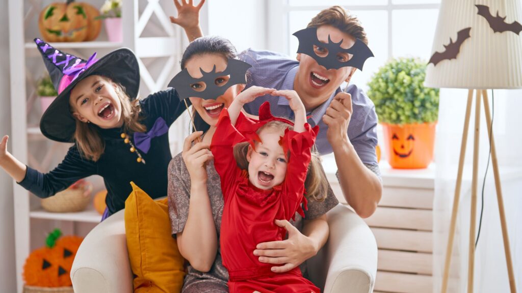 Family celebrating autism and Halloween together with costumes at home