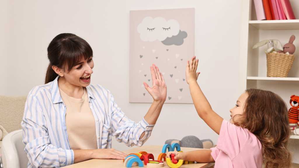 Child giving a high five during autism screening for toddlers